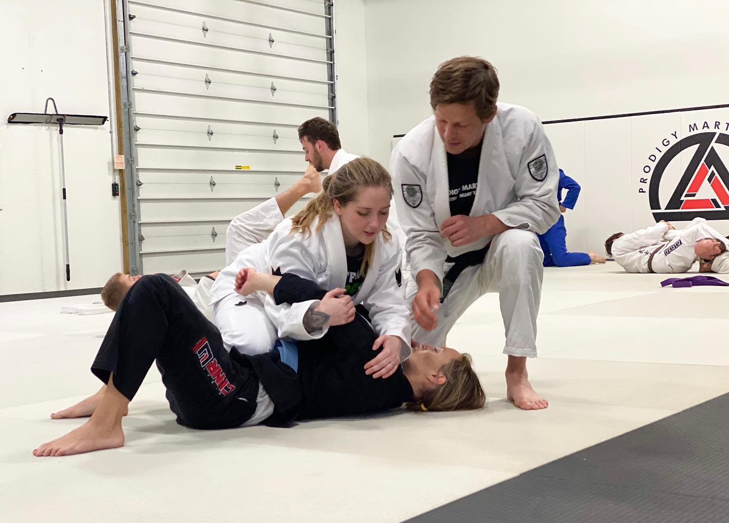 Picture showing two girls doing jiu-jitsu in blaine MN with a jiu-jitsu blackbelt