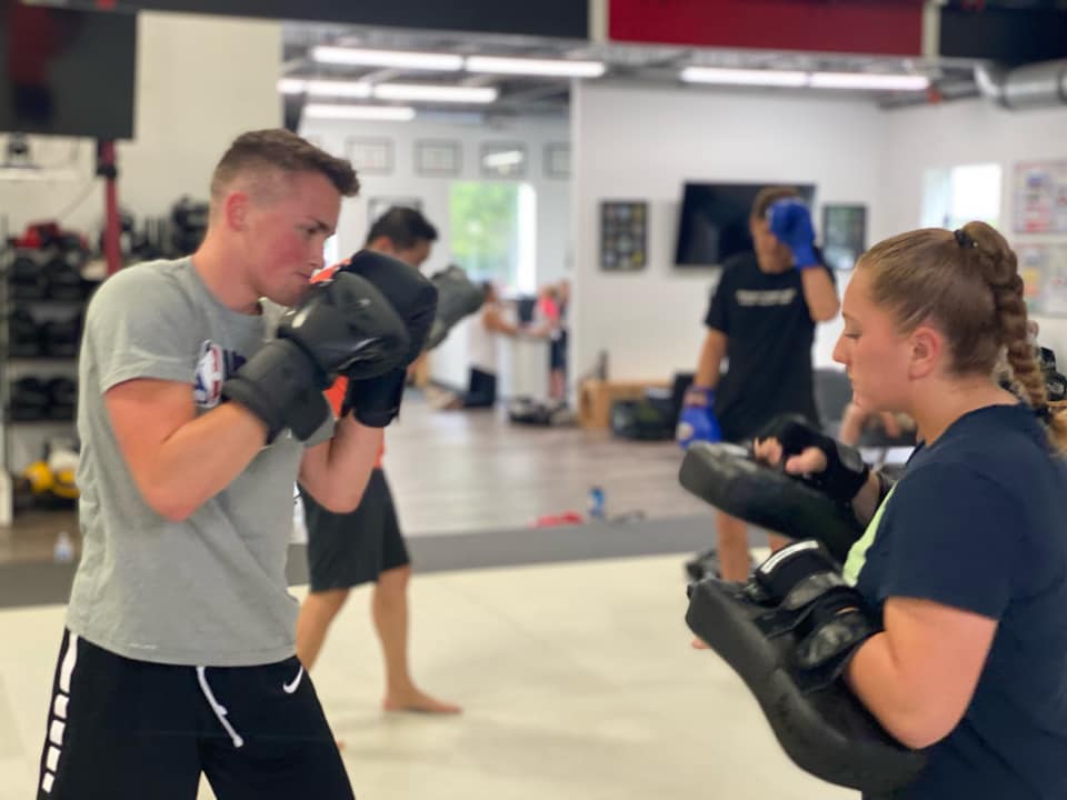 Boy and girl holding Muay Thai Pads